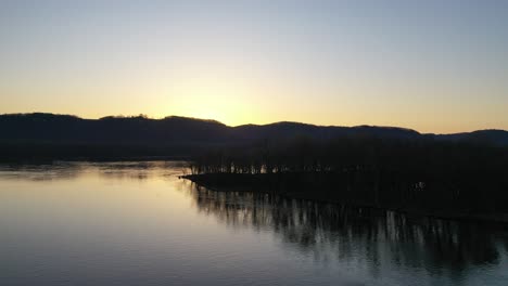 sunrise or sunset over a river and mountains