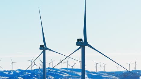 Wind-Turbines-Over-Snow-Mountains-Near-Bessaker,-Norway