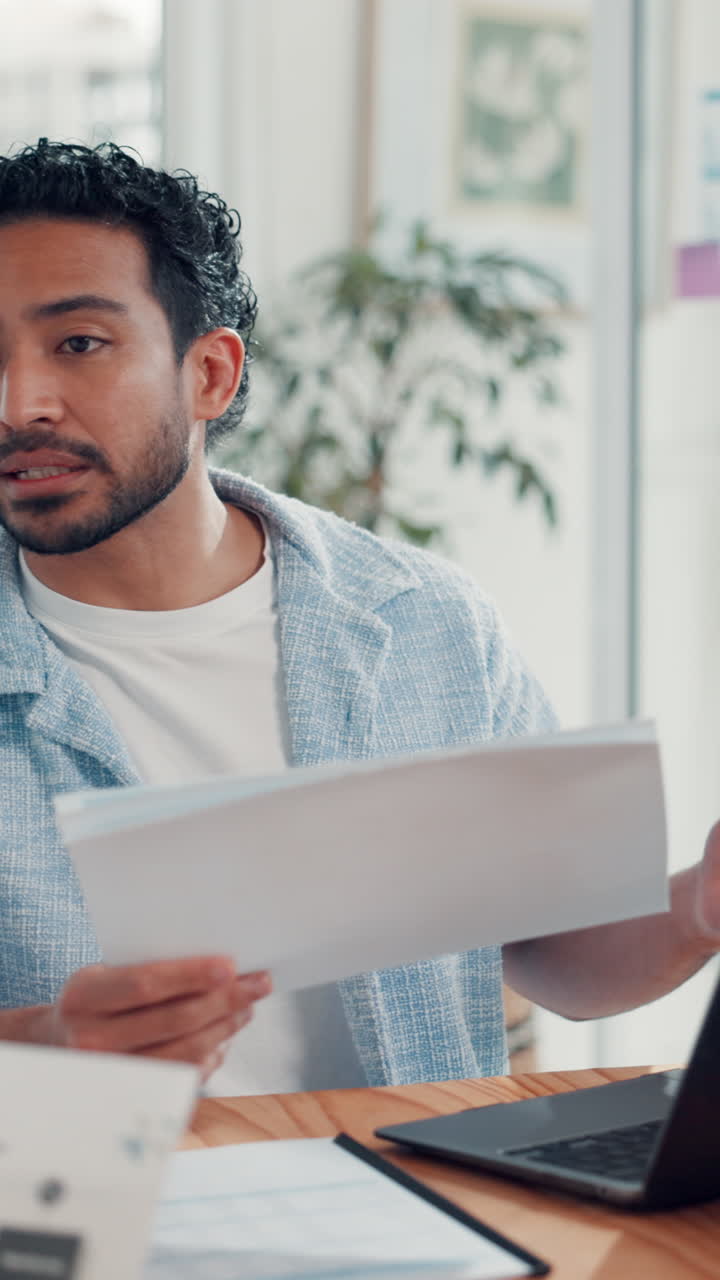 Young Man Reviewing Documents in a Modern Office