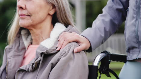 Senior,-caregiver-and-holding-shoulder