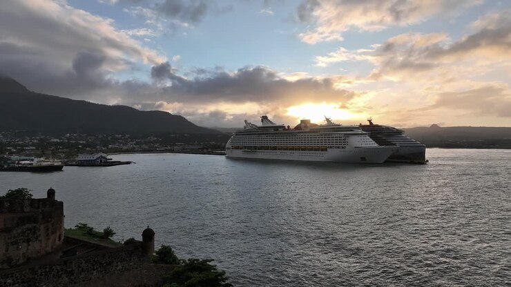 Two Cruise ships at Puerto Plata port at sunset, aerial drone view