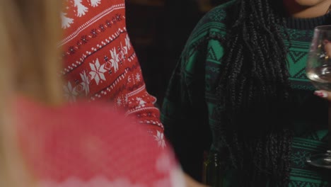 Mid-Section--Group-of-Friends-Toasting-Drinks-During-Christmas-Celebrations