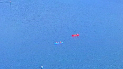 aerial: two canoes on the lake during the day in rother valley country park in the metropolitan borough of rotherham, south yorkshire, england, static drone shot