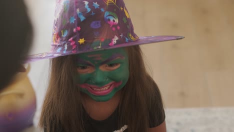 little girl getting face painted for halloween