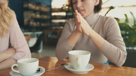 female friends sharing moments and talking in a coffee shop