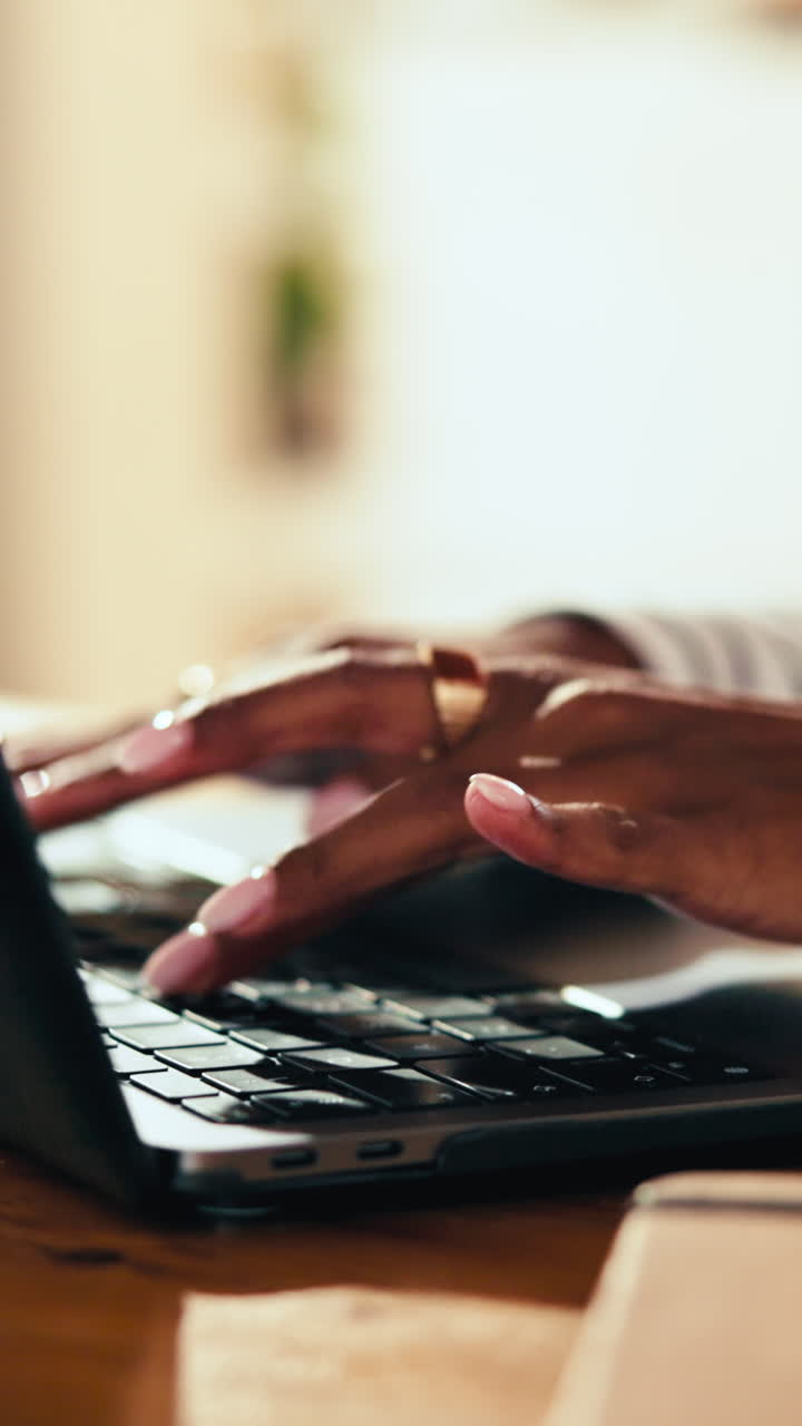Close-up of Hands Typing on Laptop Keyboard