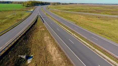 aerial road view. aerial view cars traffic on country road in field