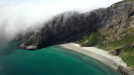 Wide-aerial-footage-of-a-rocky-coastline-in-Vaeroy,-Lofoten-Islands-in-Norway