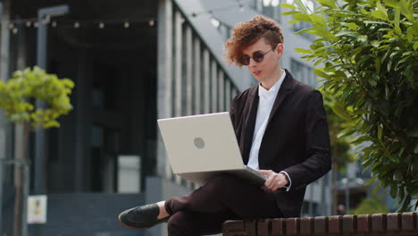 businessman investor entrepreneur working success with online project typing laptop outdoor in city
