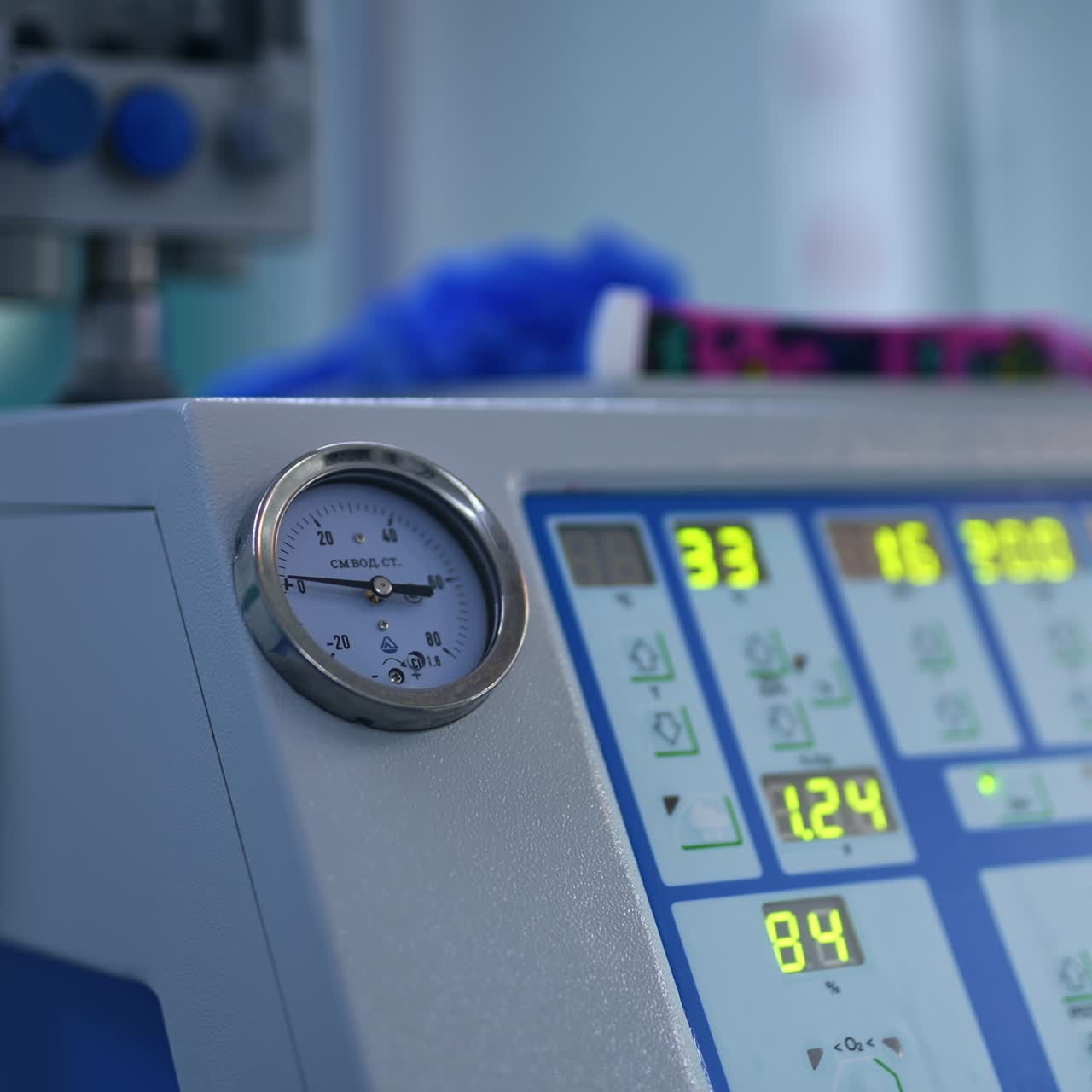 Modern equipment working in the surgery room at operation. Apparatus with diverse parameters shown at display. Close up. Blurred backdrop