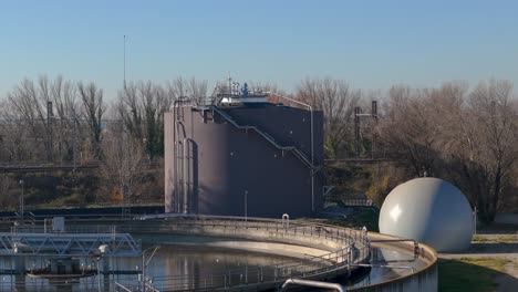 Slow-orbiting-shot-of-large-water-storage-tanks-within-a-filtration-plant