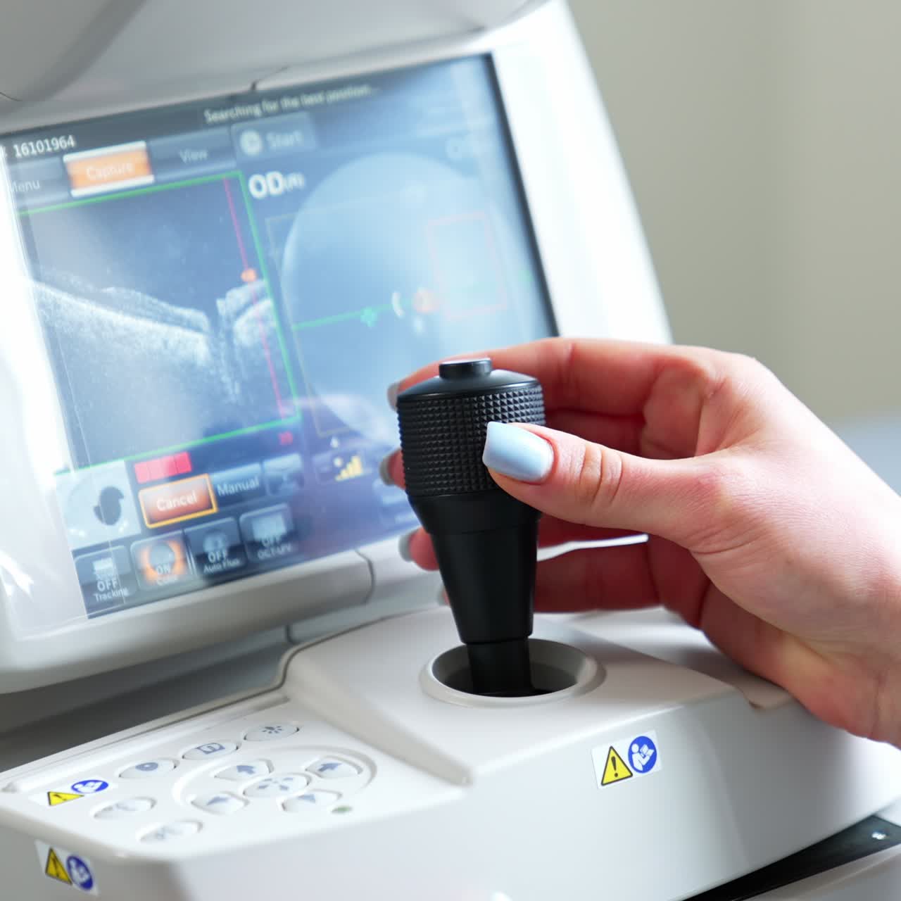 Eyesight diagnostic with the help of modern technologies. Doctor's hand turns the lever arm of a special apparatus for vision examination