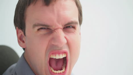 Frustrated-businessman-sitting-while-shouting