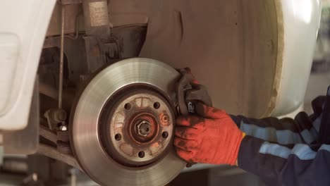 mechanic replacing brake pads