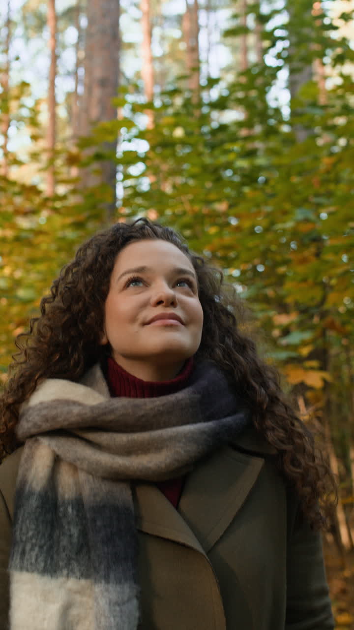 Woman with Curly Hair in Autumn Forest