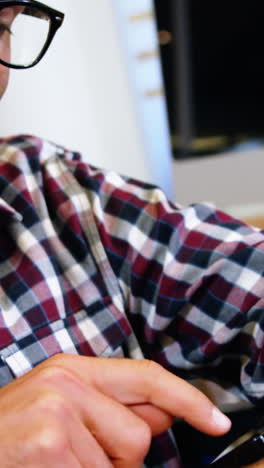 smiling businessman using his smart watch