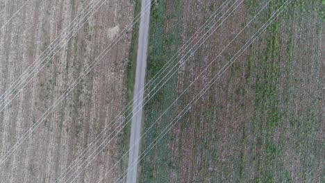 Drone-shot-of-farm-land-with-power-lines