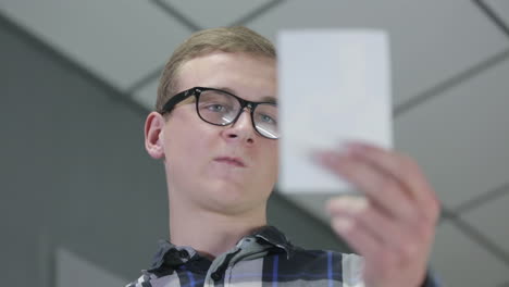 young man examining a document