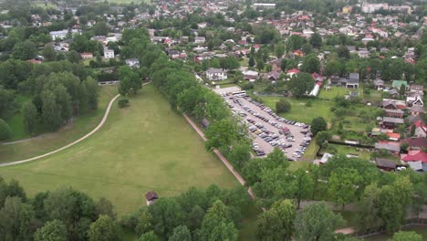 An-aerial-view-of-Valmiera-city,-showcasing-its-blend-of-urban-and-natural-elements