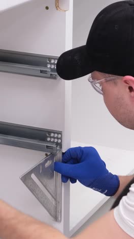a professional master during the installation of kitchen furniture a professional master during the installation of kitchen furniture installation of modern highquality furniture accessories moving to a new apartment