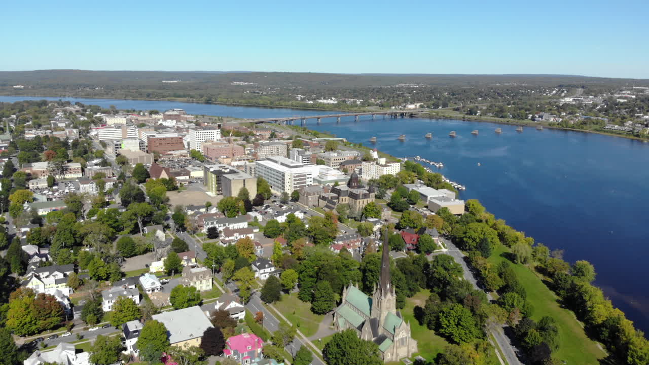 AERIAL: Rising And Moving Backward To Show City Of Fredericton And Saint John River On Sunny Summer Day.