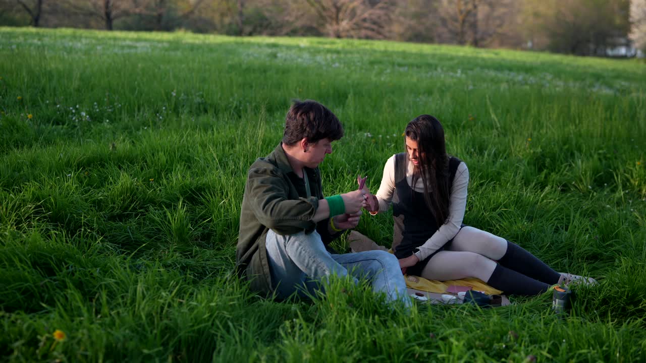 Couple Playing Cards in a Park