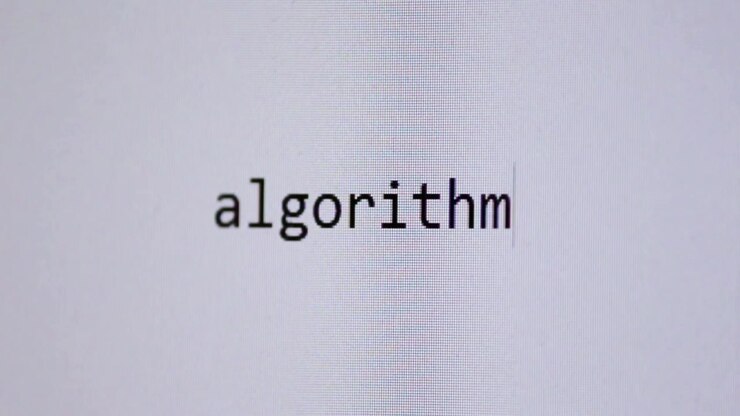Ordet “algoritme”, der indtastes på en ren, hvid digital skærm, symboliserer databehandling, kodning, automatisering og de skjulte systemer, der former online og teknologisk adfærd.