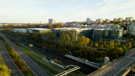 Urban-highway-intersection-with-glass-skyscraper-city-buildings-aerial-drone-view