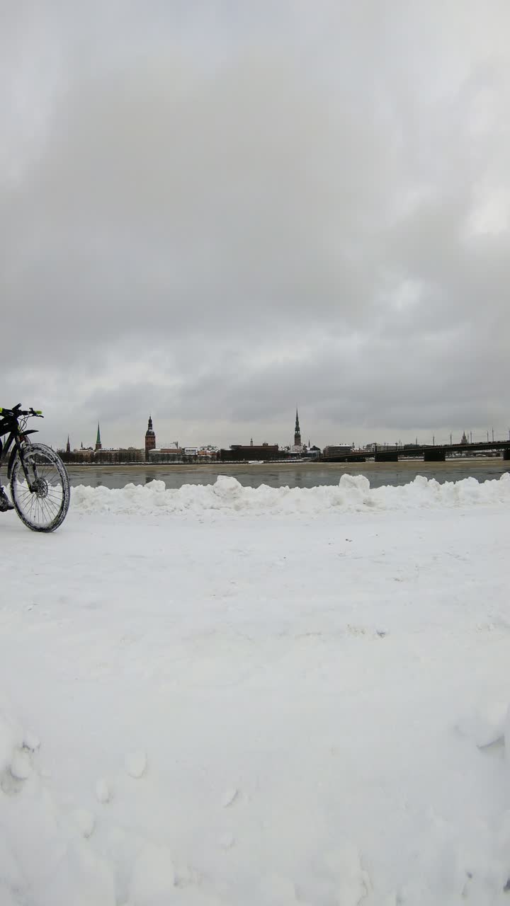 Static vertical Riga shot of cyclist drinking water showing sustainability