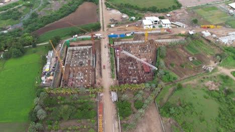 construction work of a large building is going on inside the drone camera