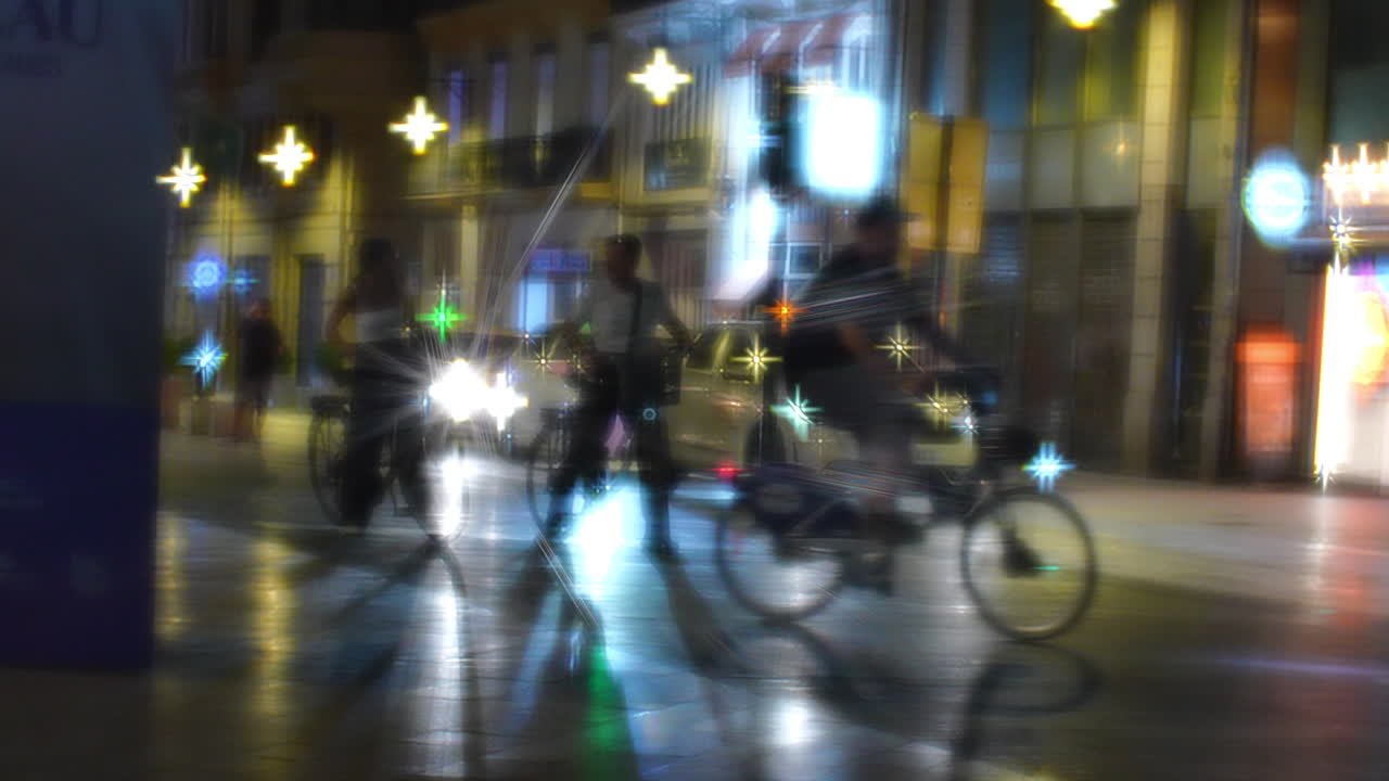 Blurry Night Scene with Cyclists and Illuminated City