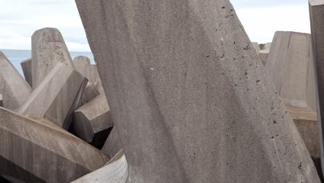 Concrete-formed-coastline-defence-geometric-shape-engineering-on-shoreline-dolly-slow-left