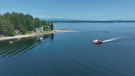 aerial view of the herron island private ferry making its hourly crossing