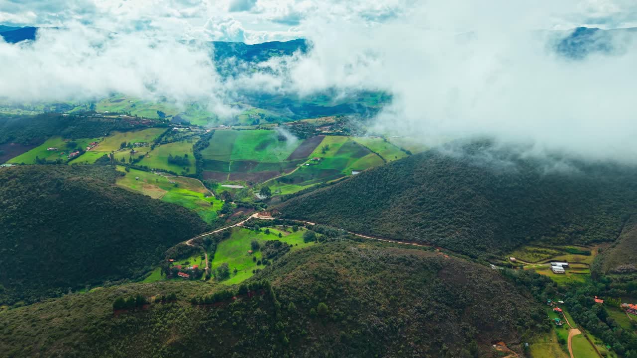 Lush green mountains wrapped in clouds showcase Guatavita’s vibrant natural beauty.