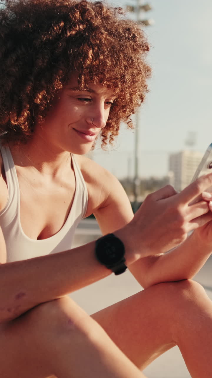 Sporty Woman Checks Phone After Workout