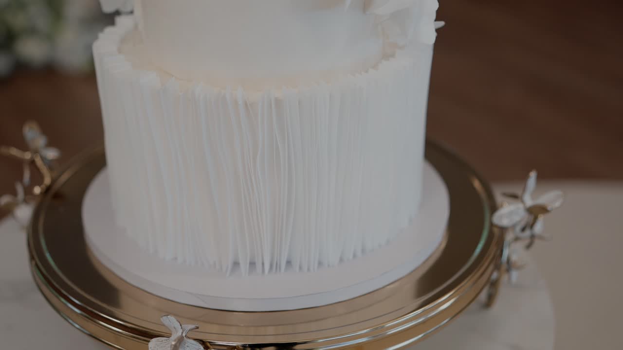elegant layered cake with modern texture design on golden base at event