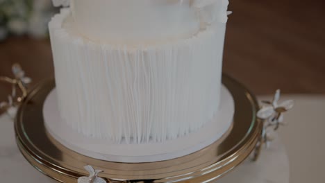 elegant layered cake with modern texture design on golden base at event