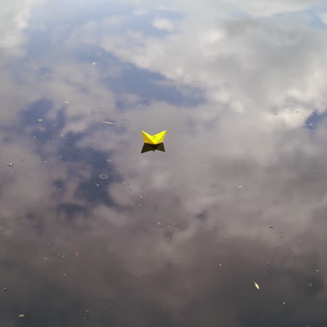 a paper boat floating on the river. origami ship sailing.