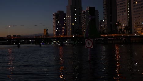 cityscape reflecting on water at night