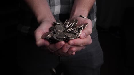 Man-tries-to-catch-coins-that-rain-down-from-above-with-his-hands