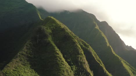 4k aerial drone pan across the hawaiian mountains at sunset