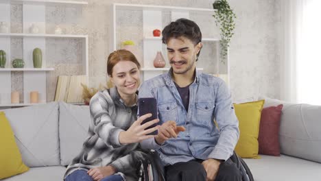 novio y novia felices miran el teléfono juntos en casa.
