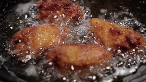 frying spanish croquetas come in focus as camera moves closer forward