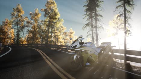 sportbike on tre road in forest with sun beams