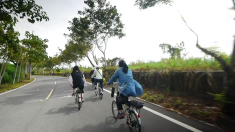 group of woman riding bicycles on countryside road