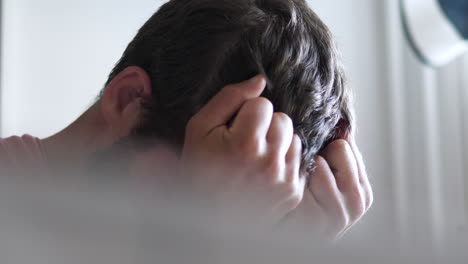 desperate stressed man covers face in anxiety, depression concept