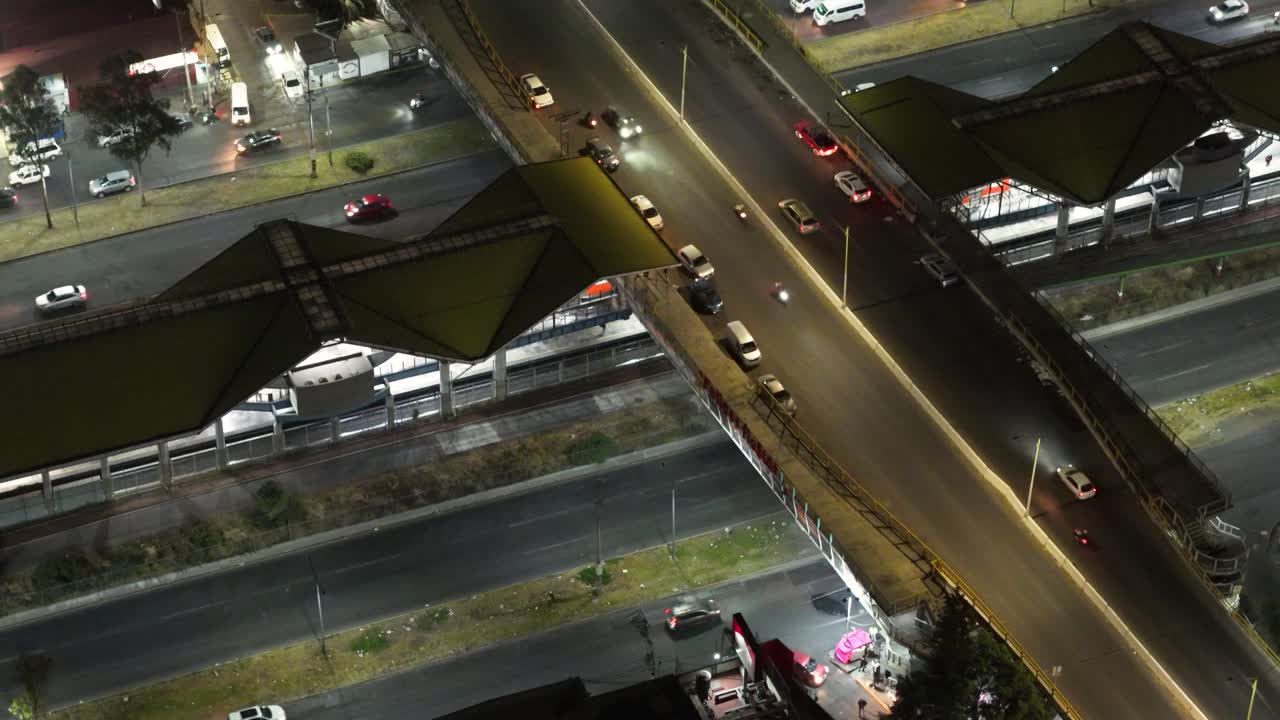Drone view showing night traffic moving across a bridge
