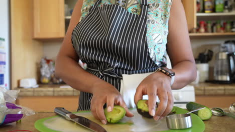 peeling a sliced avocado to add to a chopped salad - antipasto salad series