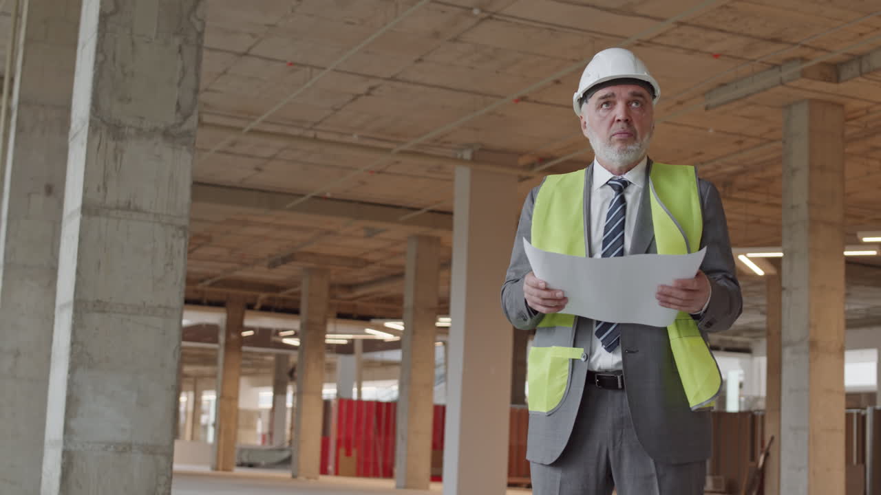 Foreman Holding Paper at Construction Site