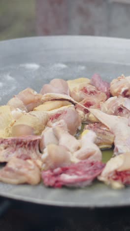 raw chicken pieces being cooked